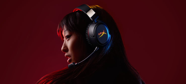 Person wearing a Cloud Flight 2 gaming headset with a red background